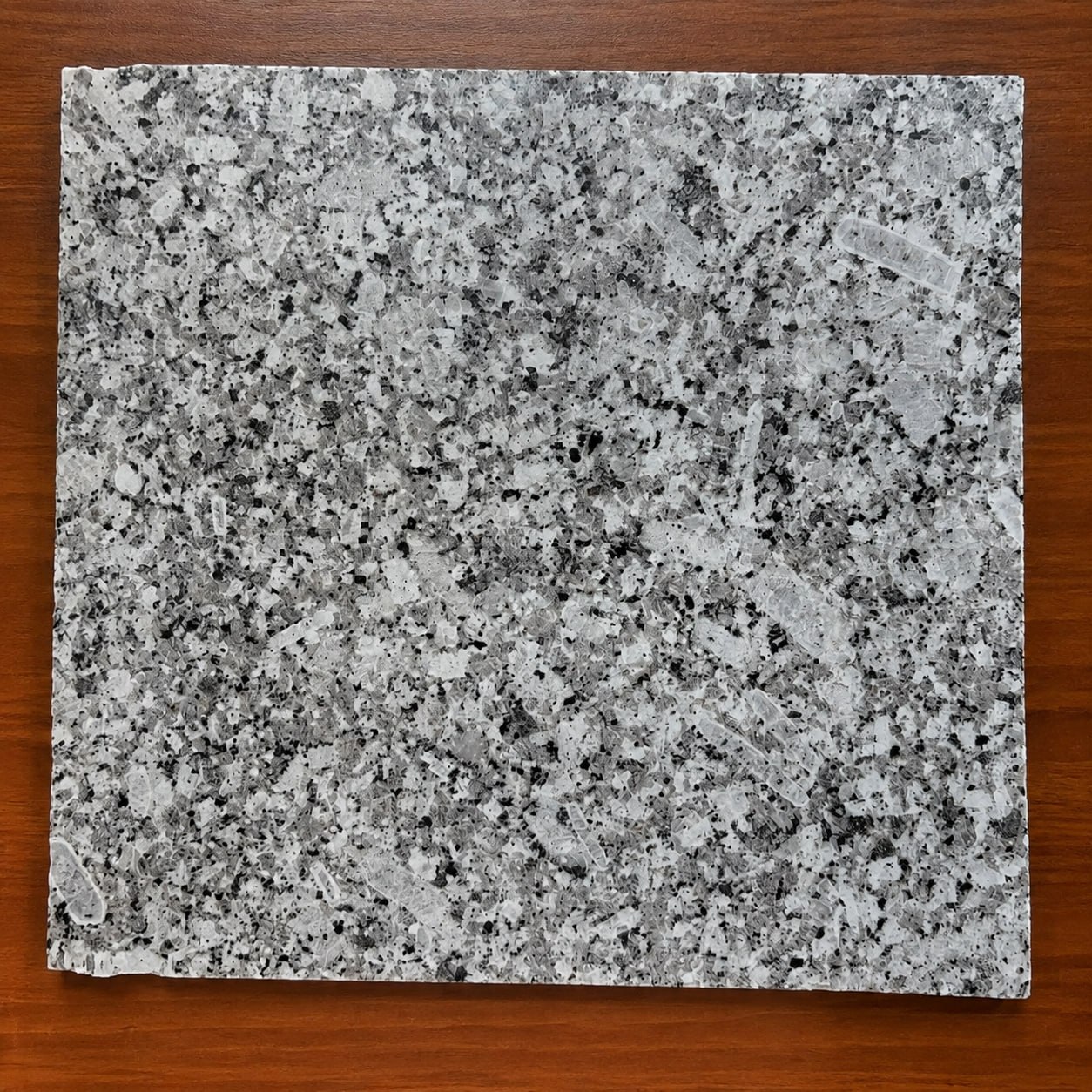 Close view of Palung Steel Grey granite crystalline structure and darker Mineral inclusions